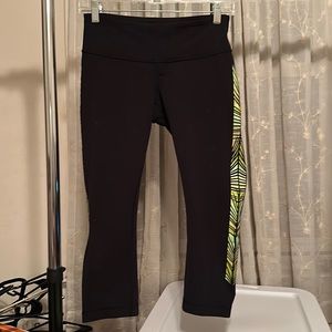 LULULEMON women’s Black Capri with yellow green pattern on side. Size 6!